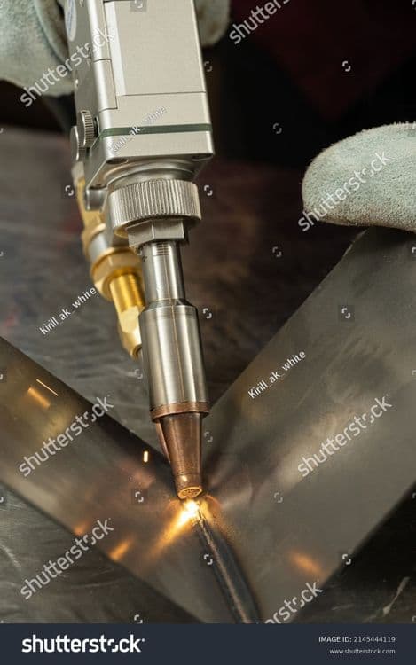 stock-photo-a-man-in-gloves-at-the-enterprise-welds-metal-products-by-laser-welding-on-a-metal-workbench-2145444119.jpg